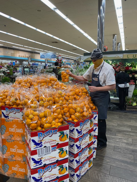 Daniel Judge stocks a citrus display in the Gelson’s Sherman Oaks store. 