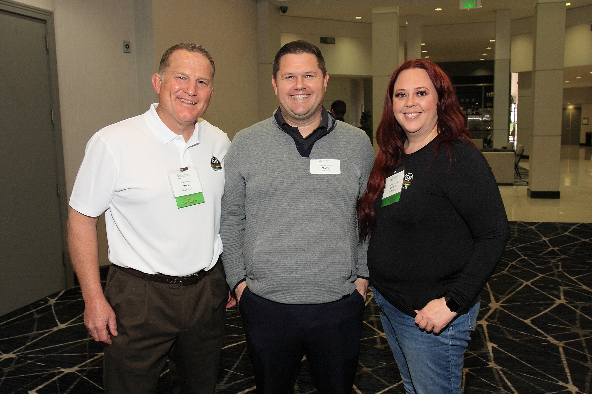 Mike Reed and Natalie Tegerdal of 68 Produce flank Matt Steinbrick of Melissa’s. 