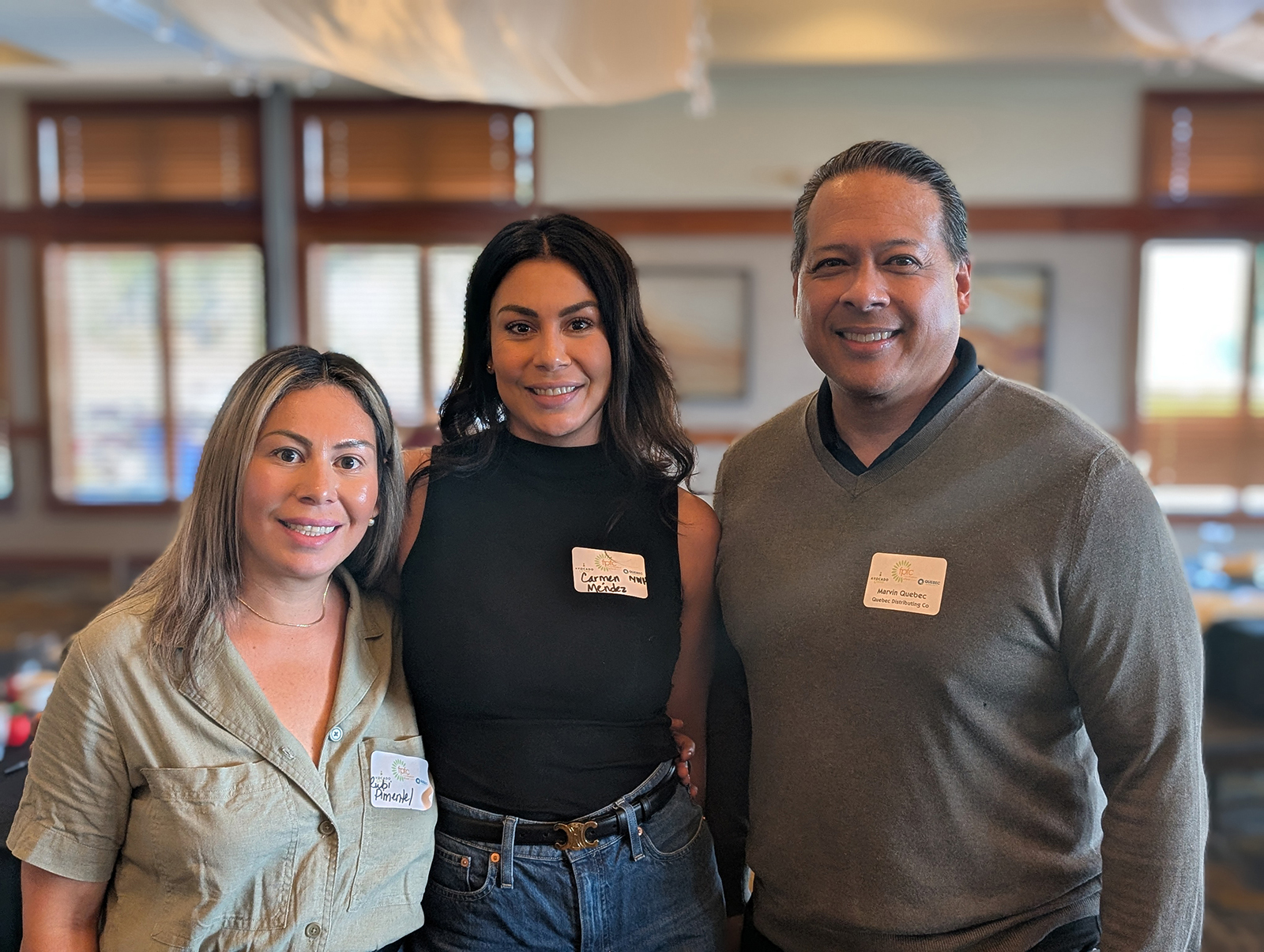 Rubi Pimentel and Carmen Mendez of Northwest Harvest with Marvin Quebec of Quebec Distributing Group.