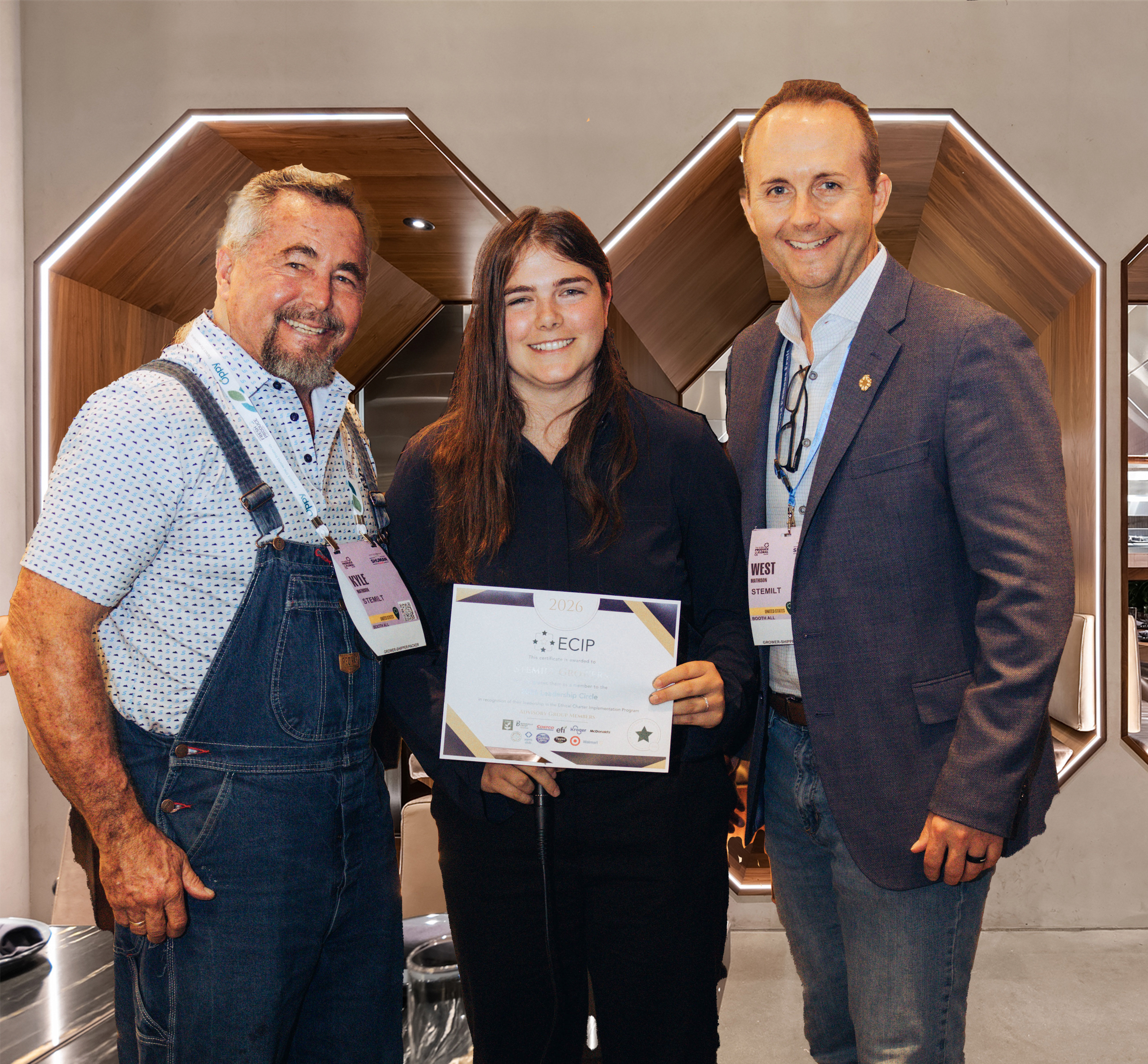 Kyle Mathison of Stemilt, Amanda Kuhn of Costco and West Mathison of Stemilt.