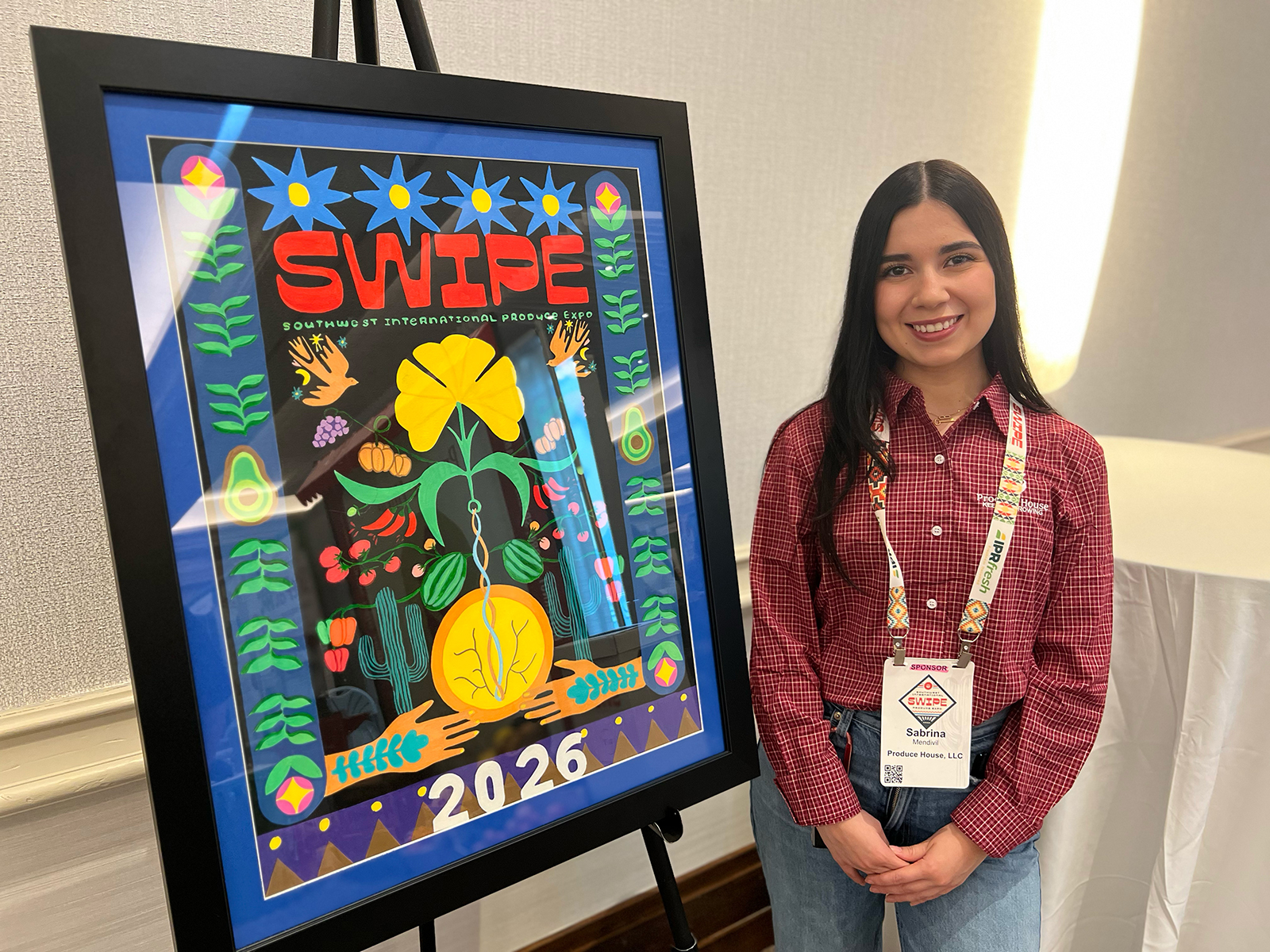 Sabrina Mendivil of Produce House with the 2026 SWIPE poster she designed. Mendivil is the daughter of FPAA Chair Raquel Espinoza of Produce House.