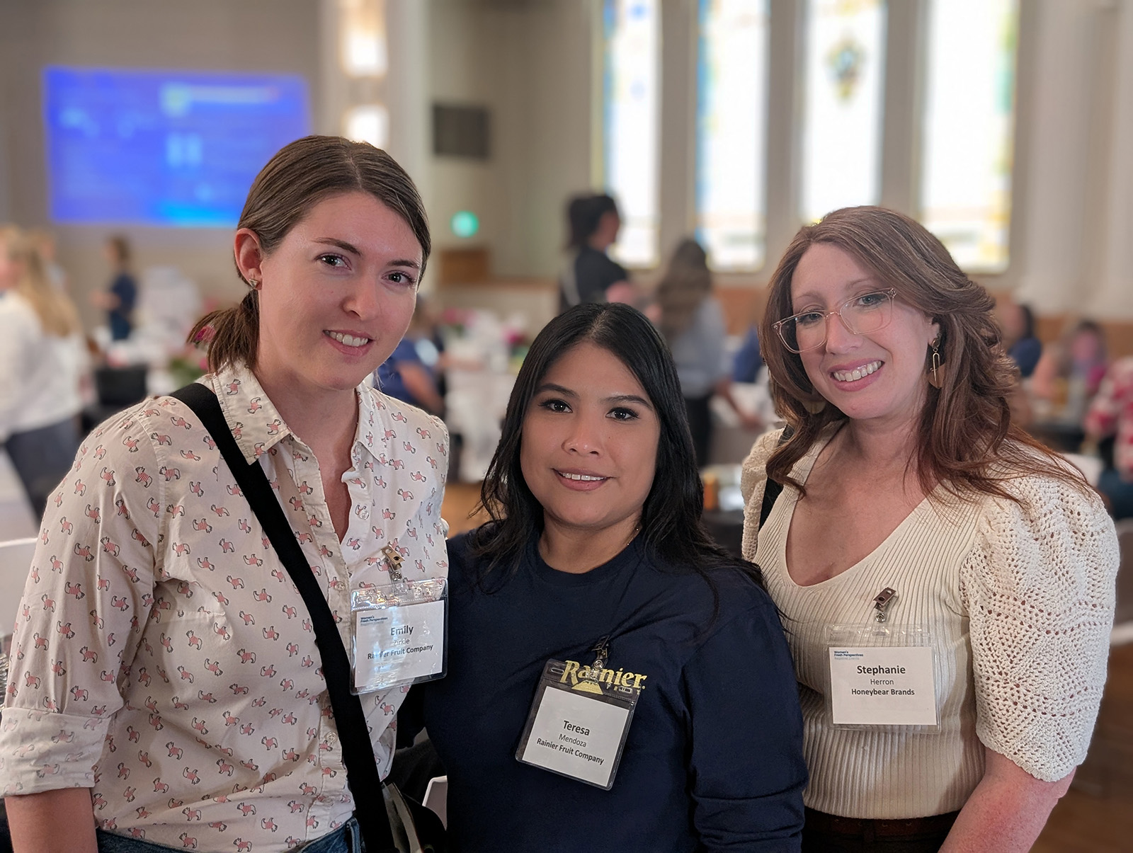Emily Zirkle and Teresa Mondez of Rainier Fruit Co. with Stephanie Herron of Honeybear Brands.