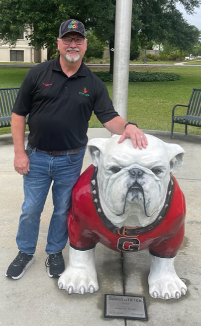 David Sherrod, SEPC's president and CEO, with a statue of the Georgia bulldog mascot.